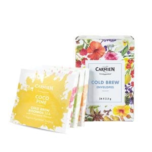 Vibrant herbal tea packaging featuring Carmién Cold Brew Envelopes and Coco Pine Rooibos Tea, showcasing natural botanicals and bright, colorful floral designs for a healthy, refreshing beverage experience.