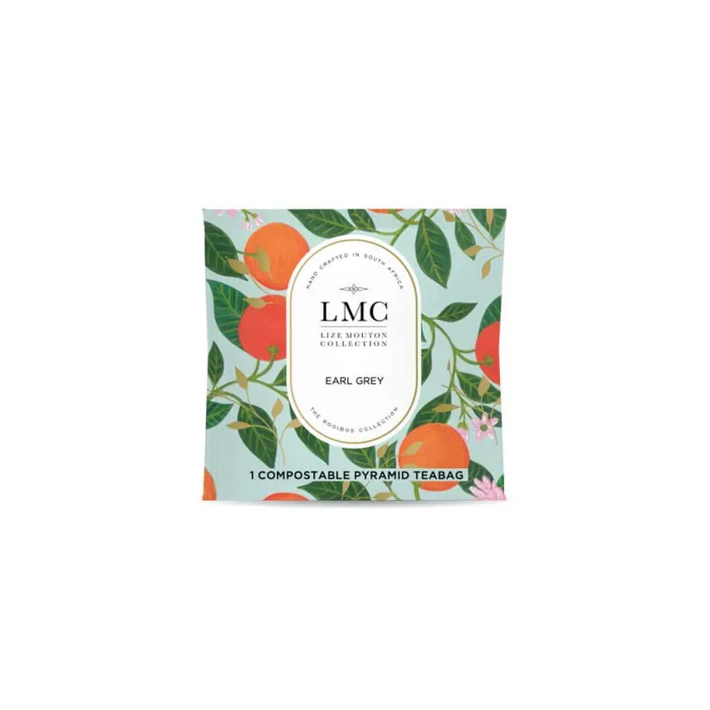 An image of LMC Earl Grey Rooibos tea envelopes from Carmién Tea, featuring vibrant orange and green botanical packaging design.