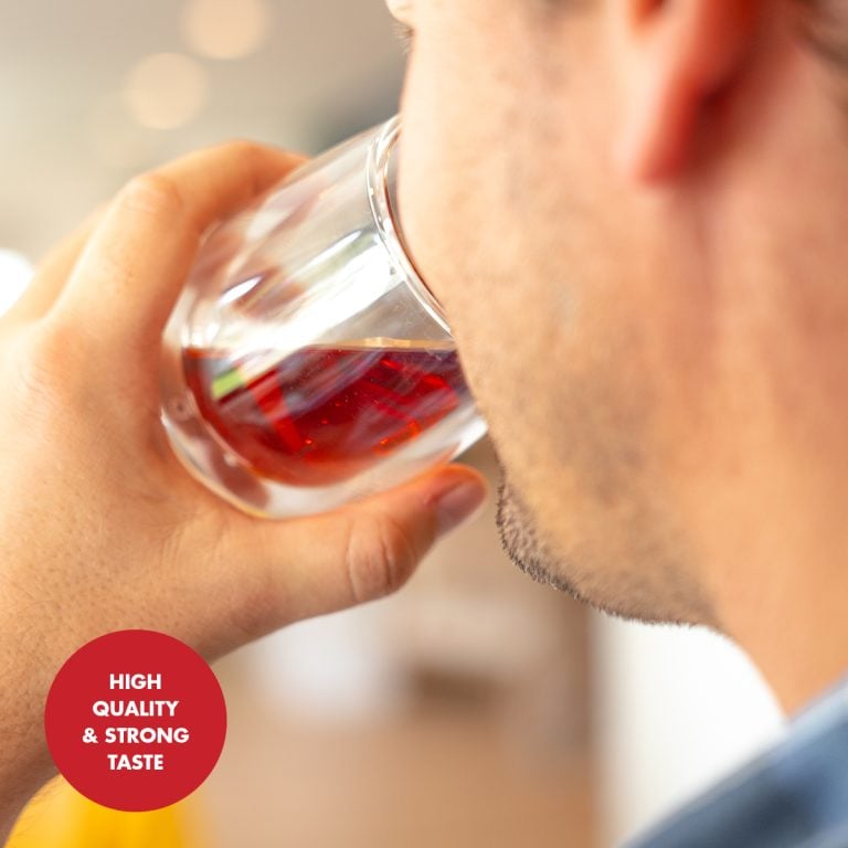 High-quality organic Rooibos tea in a glass cup, showcasing rich red infusion. Perfect for health-conscious tea lovers seeking natural, antioxidant-rich beverages.