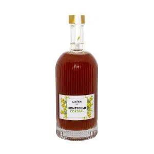 Rich honeybush herbal tea in a glass bottle with golden cap, promoting natural wellness and antioxidants.