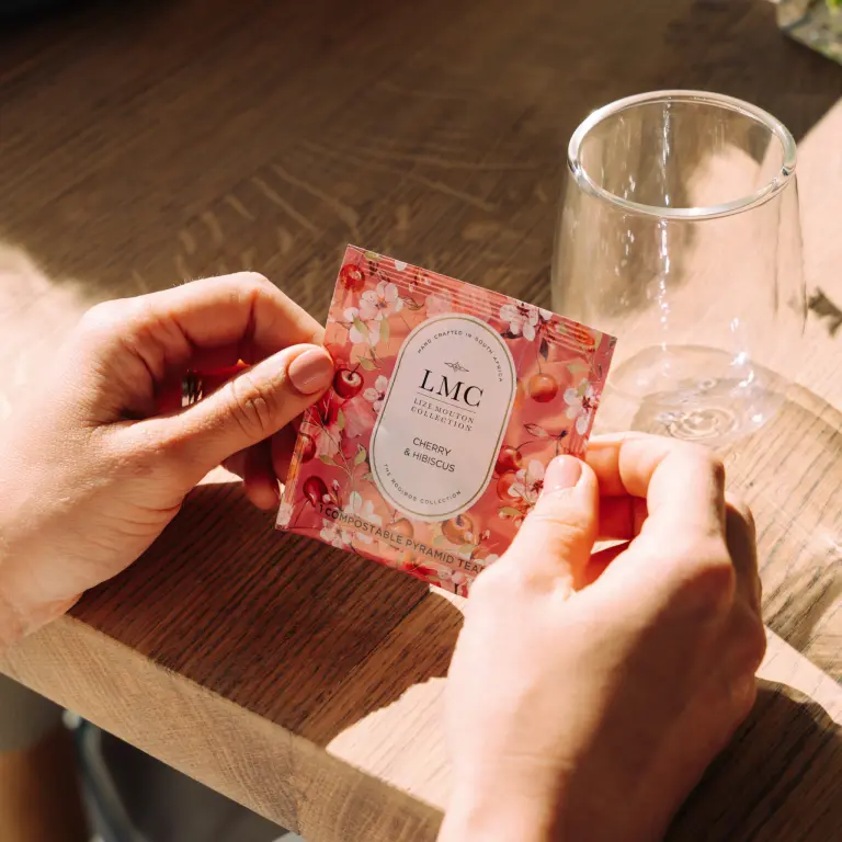 Elegant, eco-friendly CarmiĆ©n Tea packaging with cherry and hibiscus flavor, perfect for healthy tea lovers and sustainable living ā ideal for South African herbal tea enthusiasts.