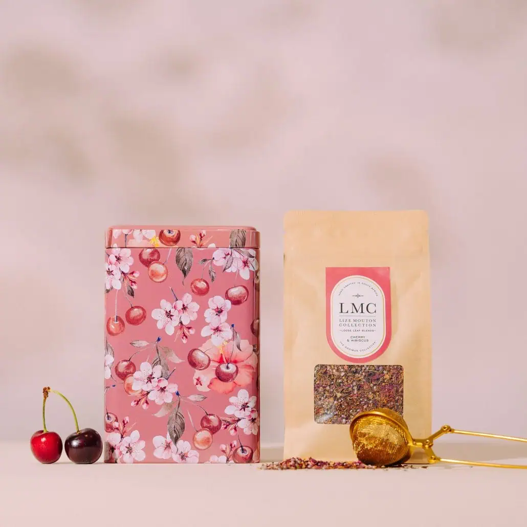 Delicious cherry and hibiscus flavored loose leaf tea from Carmién Tea collection in a pink floral tin, perfect for a refreshing and healthy beverage experience.