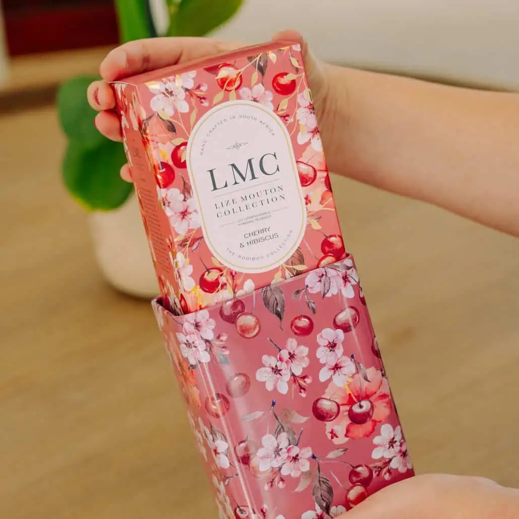 Vibrant cherry and hibiscus tea packaging from Carmién Tea, highlighting its South African roots and natural ingredients, perfect for health-conscious tea lovers.