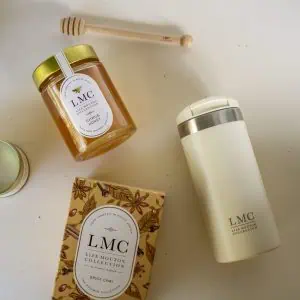 Aromatic Carmién Tea products including honey, tea, and a thermos on a white surface, highlighting natural South African herbal tea gifts and collection.