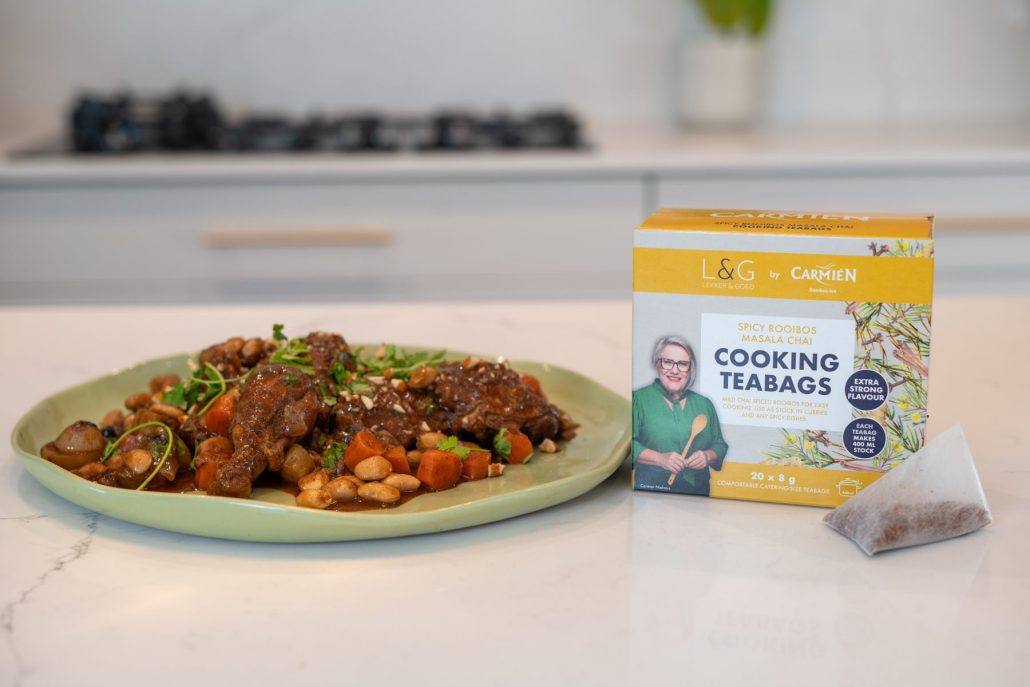 Rooibos tea used in cooking, featured in a tea bag and a delicious dish on a kitchen countertop.