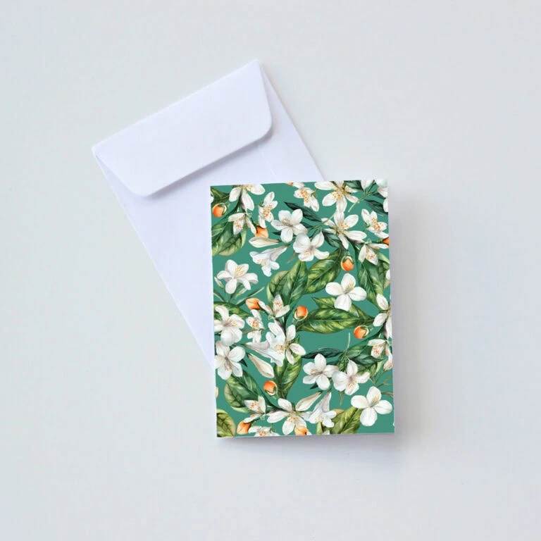 Elegant CarmiƩn Tea gift box featuring 3 x 20 teabags, perfect for gifting. Beautiful floral design with white blossoms and green leaves, showcasing premium South African herbal tea.