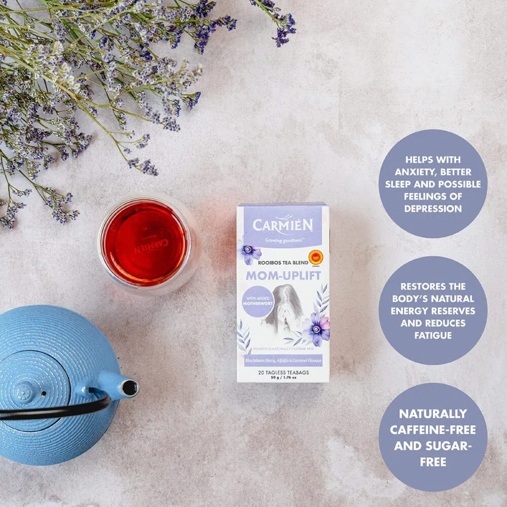 Carmién Rooibos tea box with a cup of tea, blue teapot, and lavender flowers on a light background.