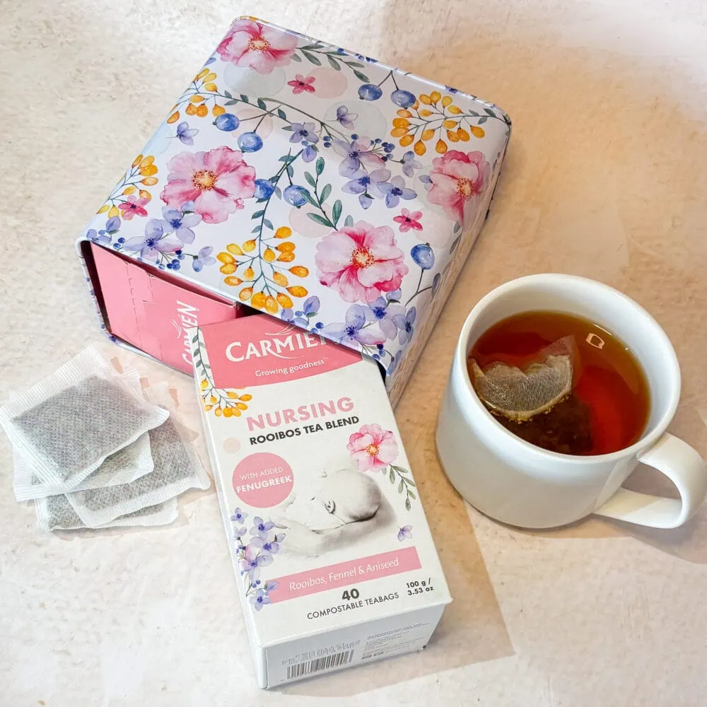 Carmién Rooibos Nursing Tea box with a cup of brewed rooibos tea, showcasing the product for health-conscious consumers.